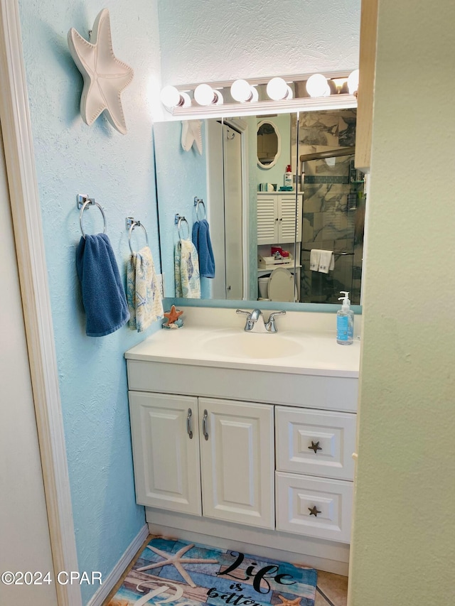 bathroom featuring tile patterned flooring and vanity