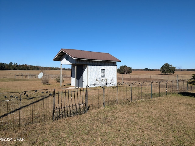 view of yard with a rural view and a storage unit