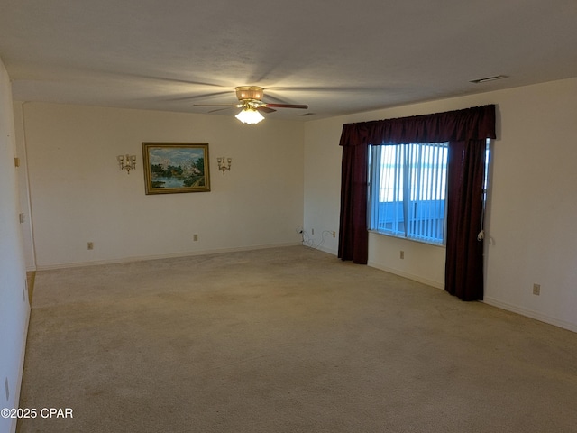 empty room with light carpet and ceiling fan