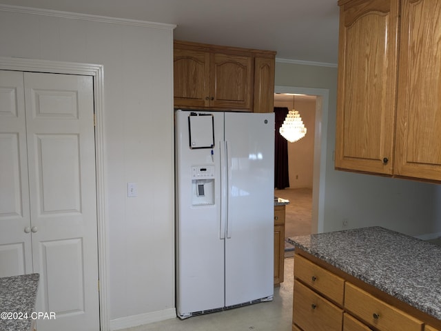 kitchen with crown molding, white refrigerator with ice dispenser, and hanging light fixtures