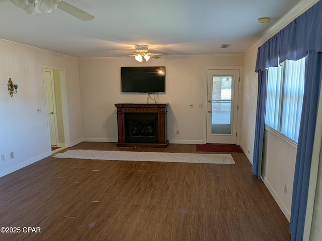 unfurnished living room with dark hardwood / wood-style floors and ceiling fan