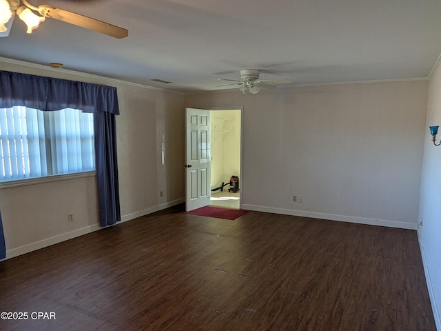 unfurnished room featuring ornamental molding, ceiling fan, and dark wood-type flooring