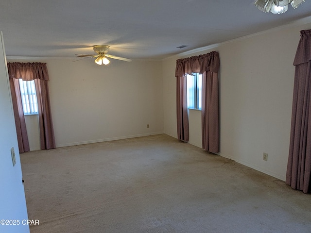 unfurnished room with ceiling fan, a healthy amount of sunlight, and light carpet