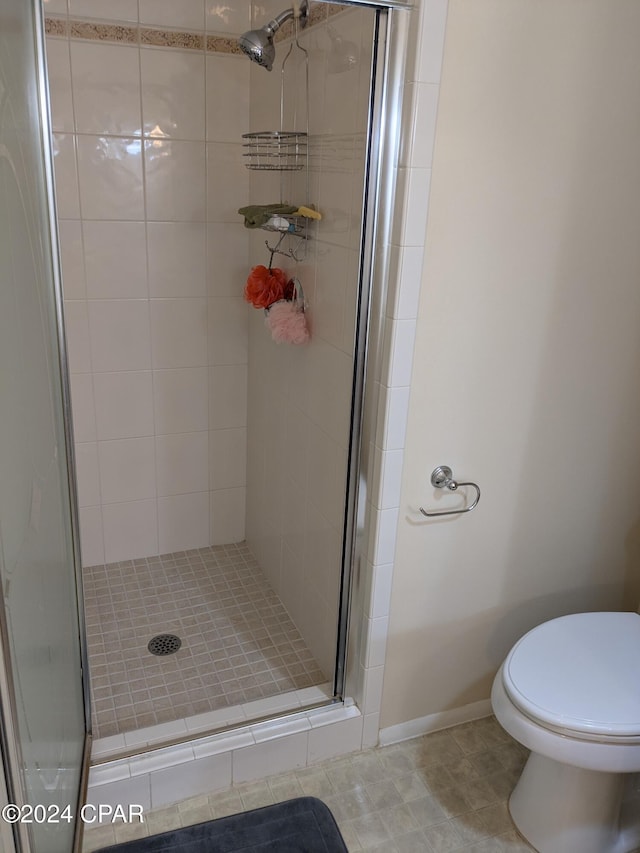 bathroom with toilet and walk in shower