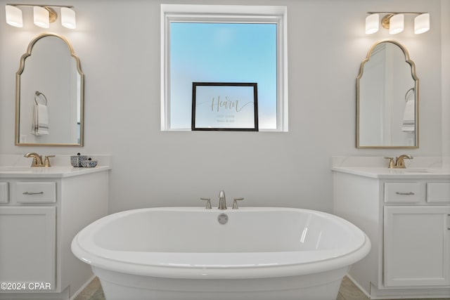 bathroom with vanity and a tub