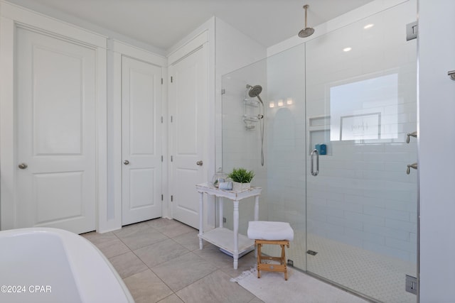 bathroom featuring tile patterned floors and an enclosed shower