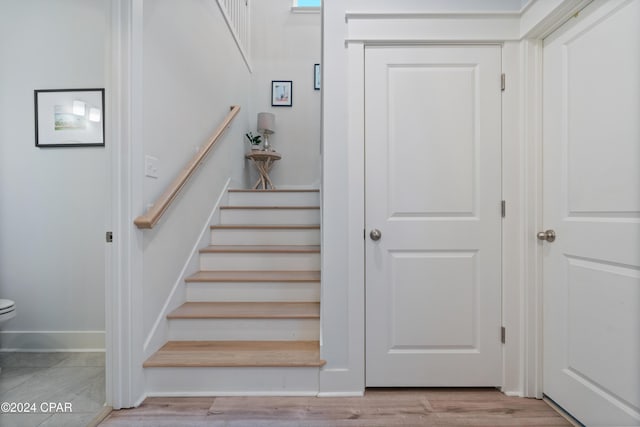 stairs featuring hardwood / wood-style flooring