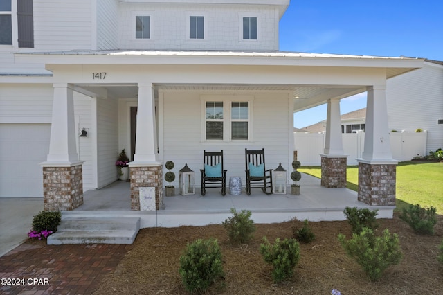 exterior space with a garage and covered porch