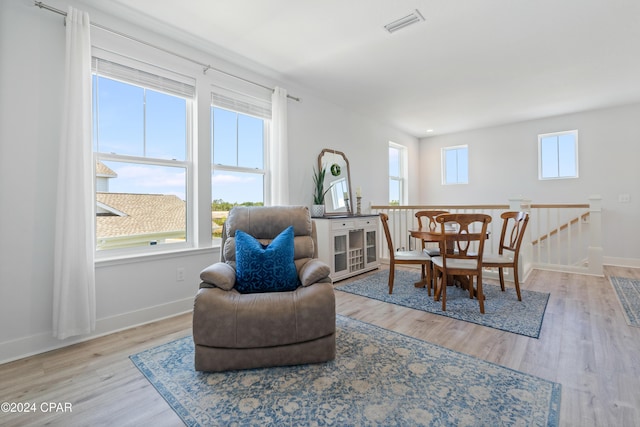 sitting room featuring plenty of natural light and light hardwood / wood-style floors