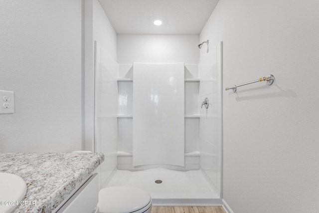 bathroom with walk in shower, toilet, vanity, and hardwood / wood-style flooring