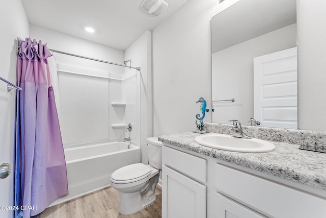 full bathroom with shower / bath combination with curtain, vanity, wood-type flooring, and toilet