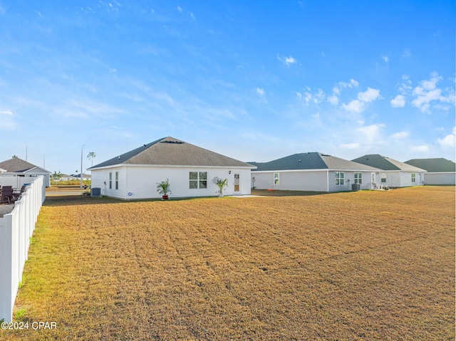 rear view of property featuring a lawn