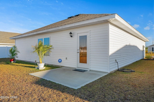 rear view of property with a patio area and a lawn