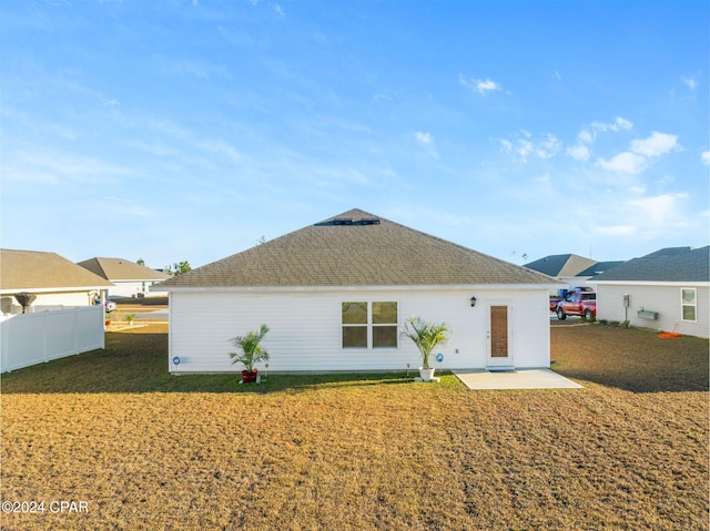 rear view of house with a lawn