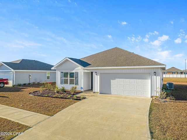 ranch-style house with cooling unit and a garage