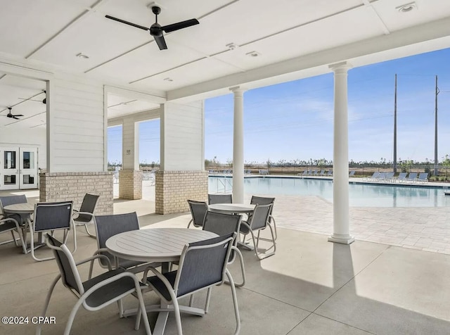 view of patio featuring a water view and a community pool