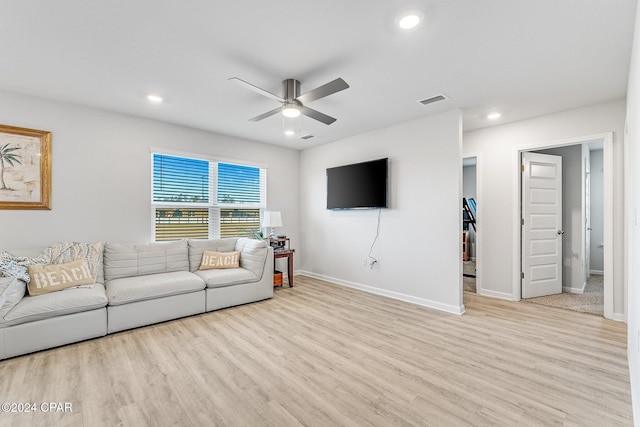 living room featuring light hardwood / wood-style flooring and ceiling fan