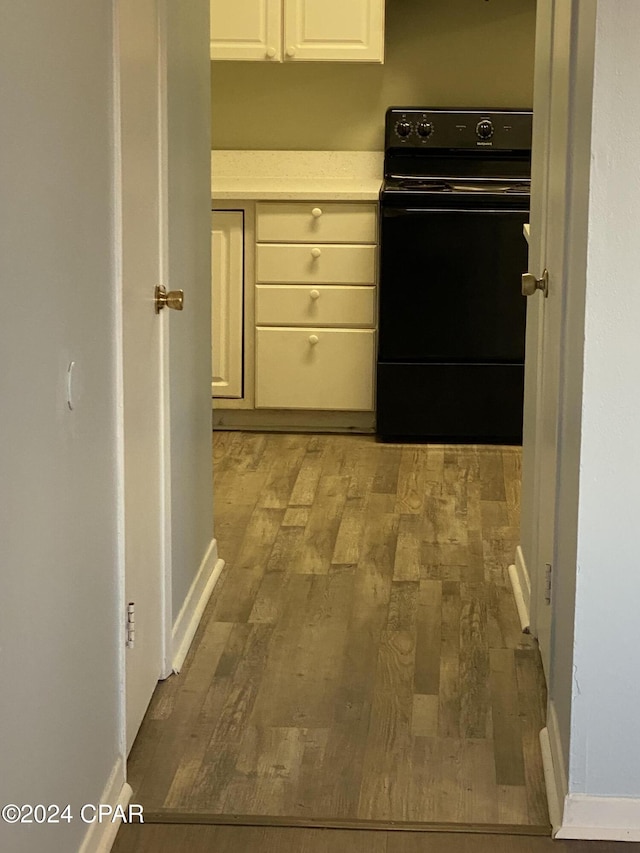 kitchen featuring light hardwood / wood-style flooring and black range