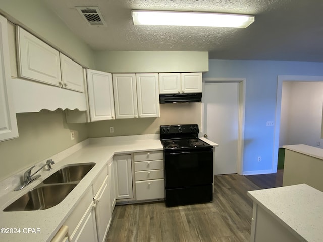 kitchen with electric range, sink, and white cabinets