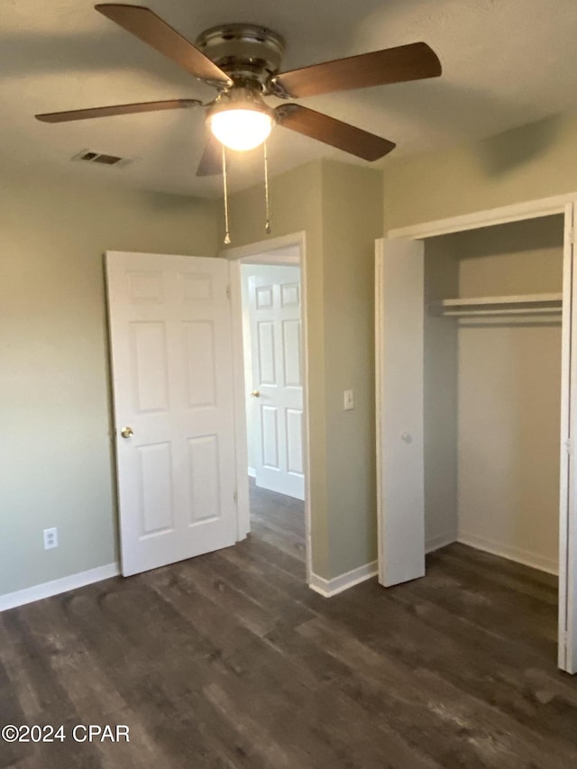 unfurnished bedroom featuring a closet, ceiling fan, and dark wood-type flooring