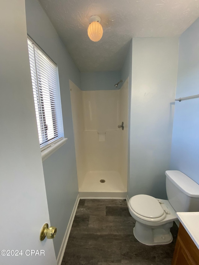 bathroom featuring a shower, vanity, and a wealth of natural light