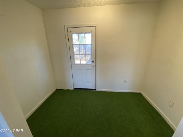 doorway to outside with dark carpet