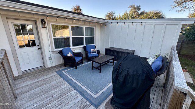 wooden deck with an outdoor living space