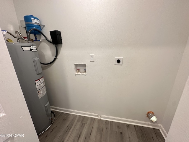 clothes washing area with dark hardwood / wood-style flooring, electric water heater, hookup for a washing machine, and electric dryer hookup