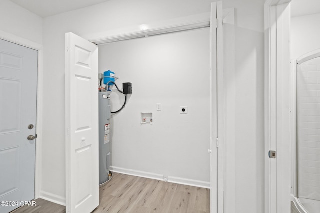 laundry area featuring hookup for a washing machine, electric water heater, light hardwood / wood-style flooring, and electric dryer hookup