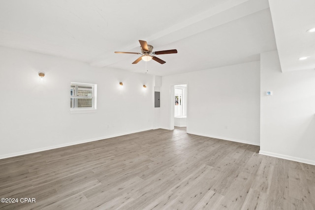 unfurnished room with ceiling fan, light wood-type flooring, and electric panel