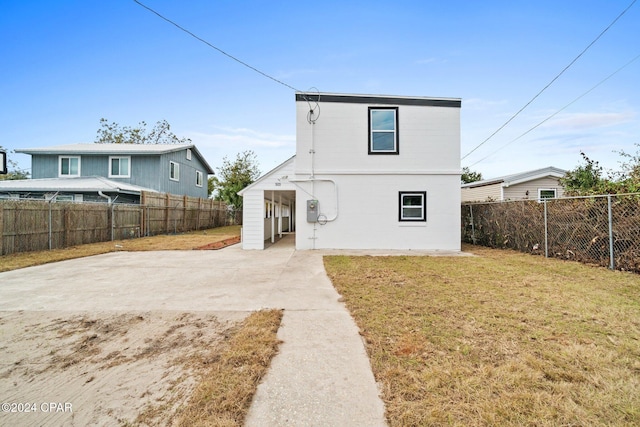 rear view of house with a lawn