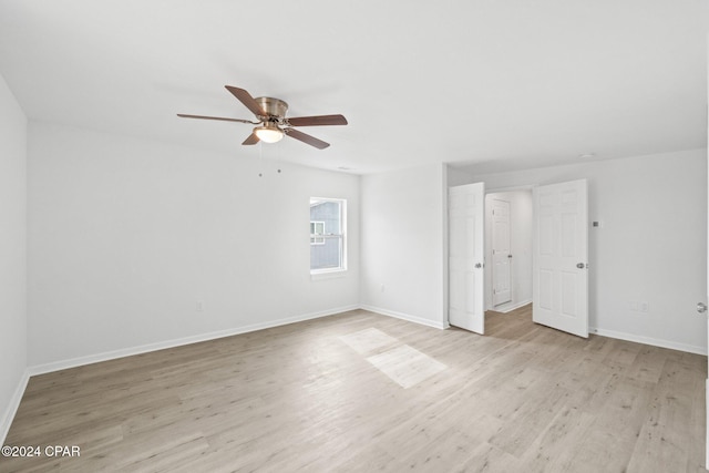 spare room featuring light hardwood / wood-style flooring and ceiling fan