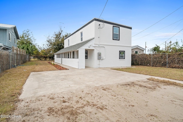 back of house featuring a yard and a patio