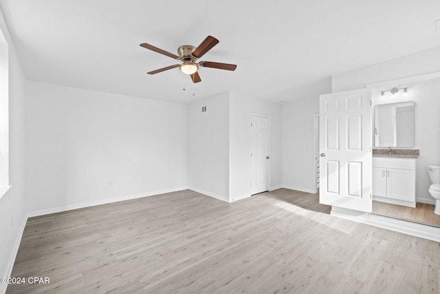 interior space featuring ceiling fan, light wood-type flooring, and sink