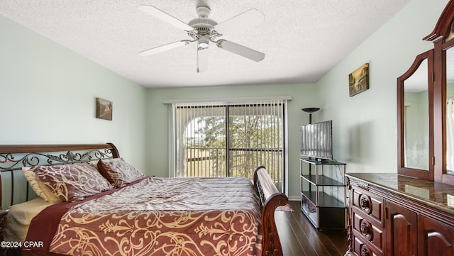 bedroom featuring dark hardwood / wood-style floors, a textured ceiling, and ceiling fan