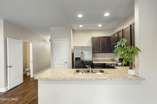 kitchen with black range oven, sink, stainless steel refrigerator with ice dispenser, dark hardwood / wood-style floors, and dark brown cabinets