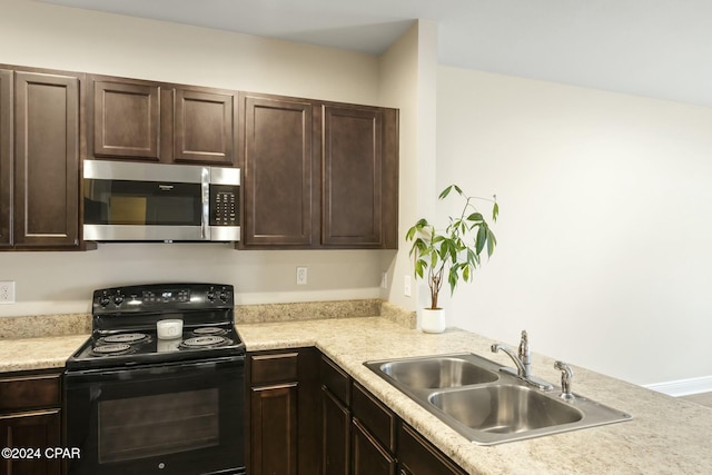 kitchen featuring dark brown cabinets, sink, and black range with electric cooktop