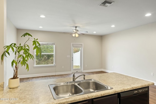 kitchen with hardwood / wood-style flooring, sink, ceiling fan, and black dishwasher