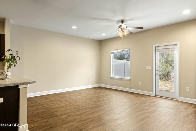 unfurnished living room featuring hardwood / wood-style floors and ceiling fan