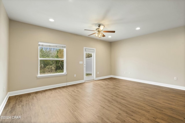 unfurnished room with hardwood / wood-style flooring and ceiling fan