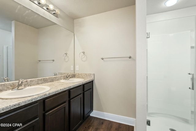 bathroom with vanity, hardwood / wood-style flooring, and walk in shower