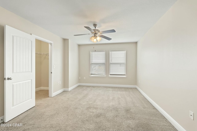 spare room featuring light colored carpet and ceiling fan