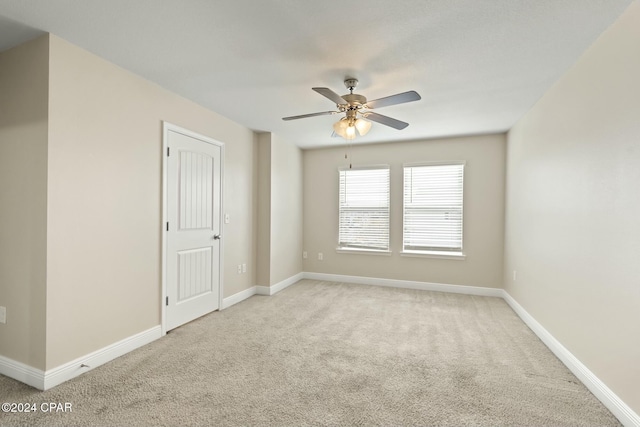 carpeted empty room featuring ceiling fan