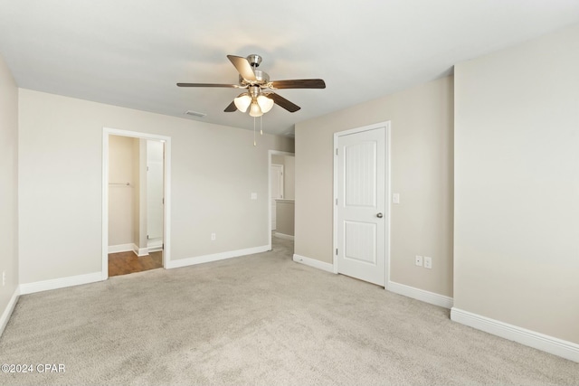 unfurnished bedroom with ceiling fan, a closet, and light colored carpet