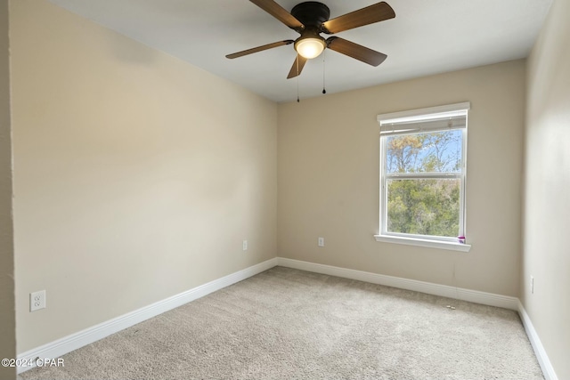 carpeted spare room with ceiling fan