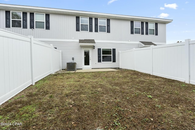 back of house featuring a lawn, central air condition unit, and a patio