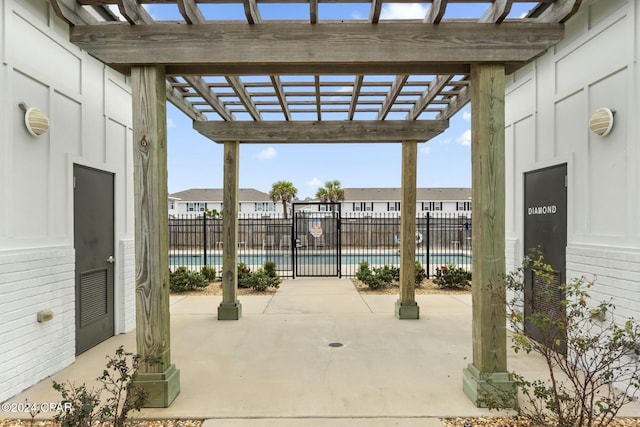 view of patio with a pergola and a community pool