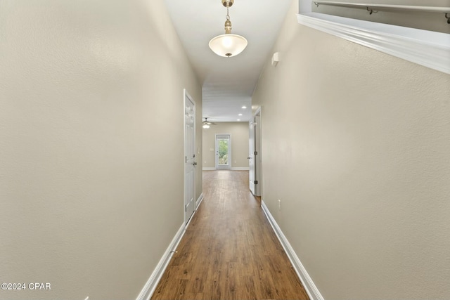 hallway with hardwood / wood-style floors