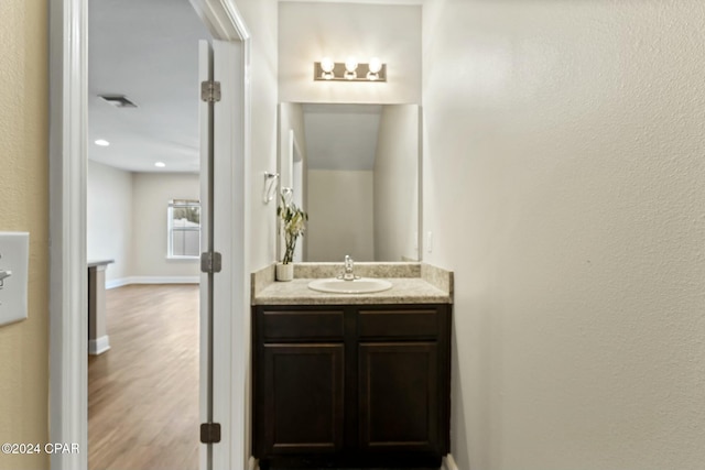 bathroom featuring vanity and wood-type flooring