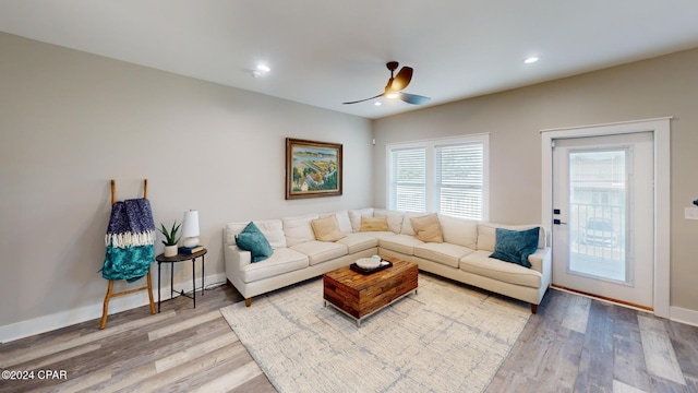 living room featuring ceiling fan and hardwood / wood-style flooring